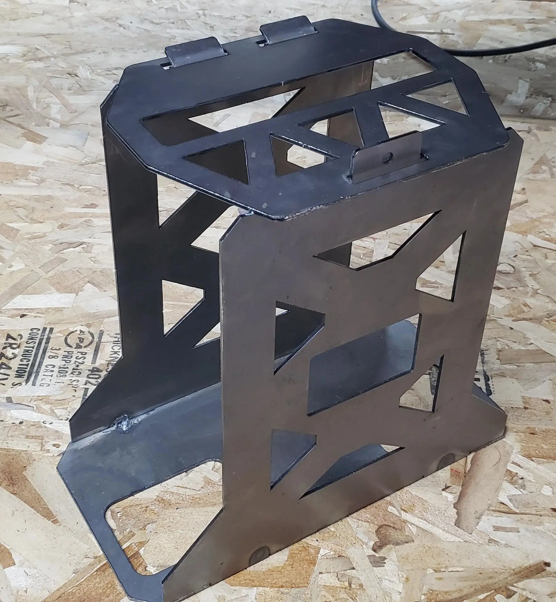 A metal stand sitting on top of a wooden floor.