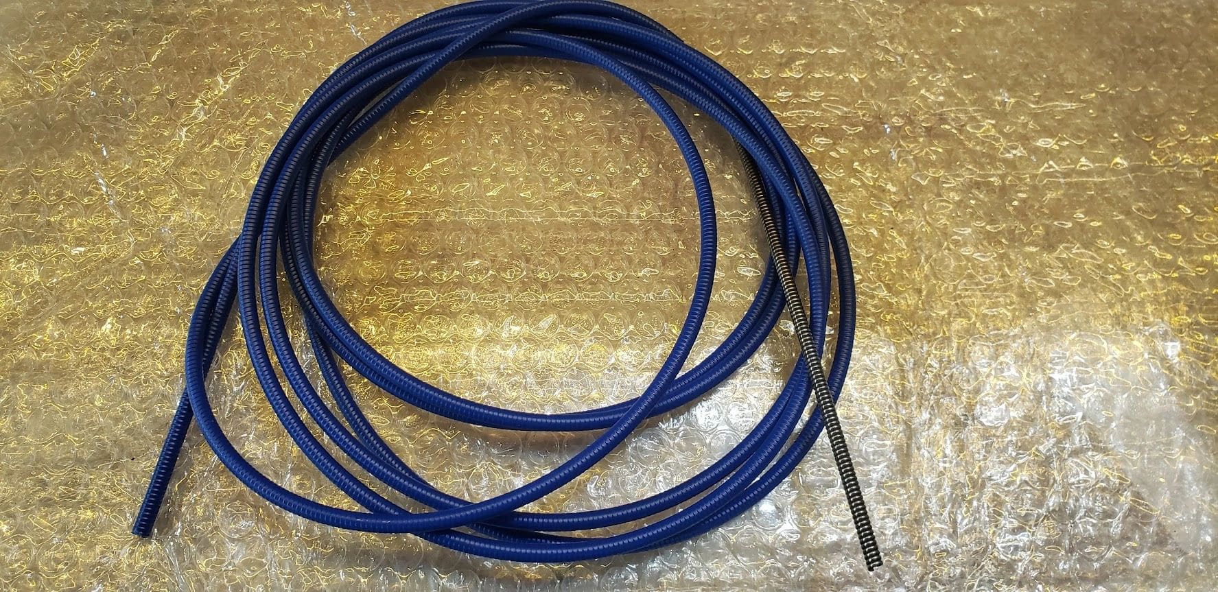 A blue cord is laying on the ground