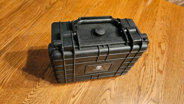 A black case sitting on top of a wooden floor.