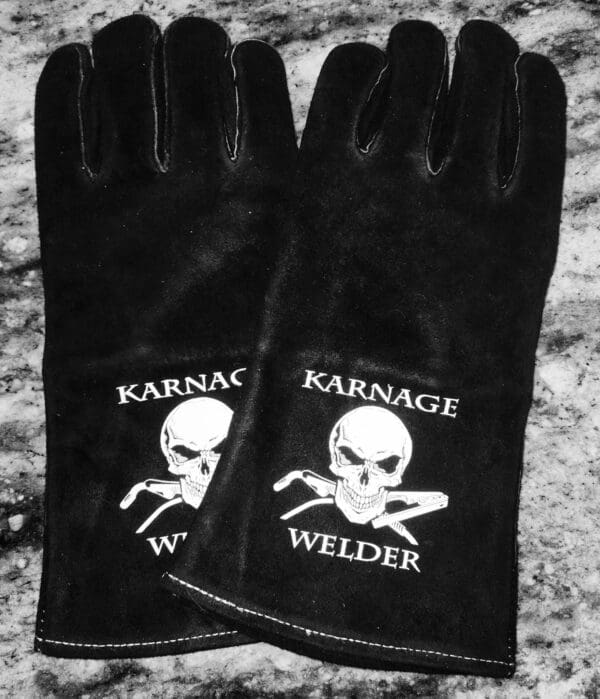 A pair of black gloves with a skull and crossbones on them.