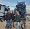 A group of people standing in front of an rv.